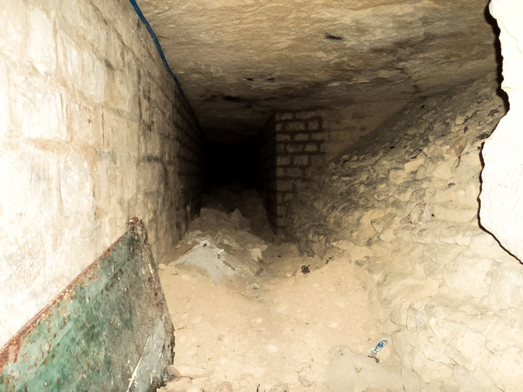 Dark tunnel in the Paris Catacombs. 