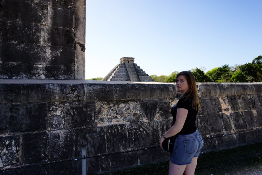 Inside ball court of Chichen Itza, El Castillo in background. 