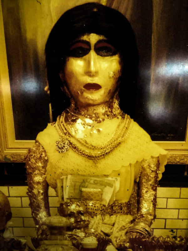Golden stature of Mae Nak at her shrine. 